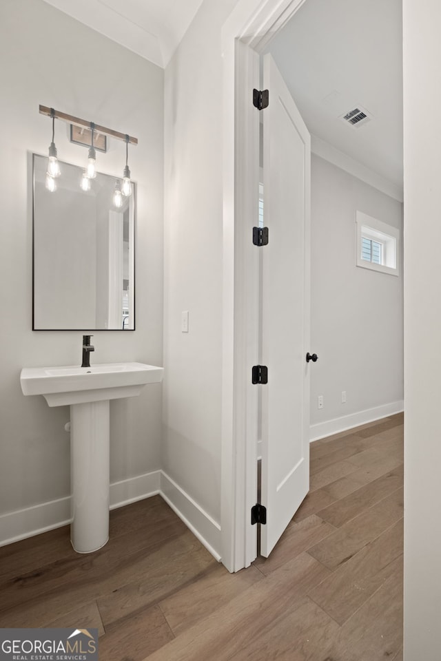 4002 Potter Way, Woodstock, GA 30188 - bathroom with baseboards, wood finished floors, and ornamental molding