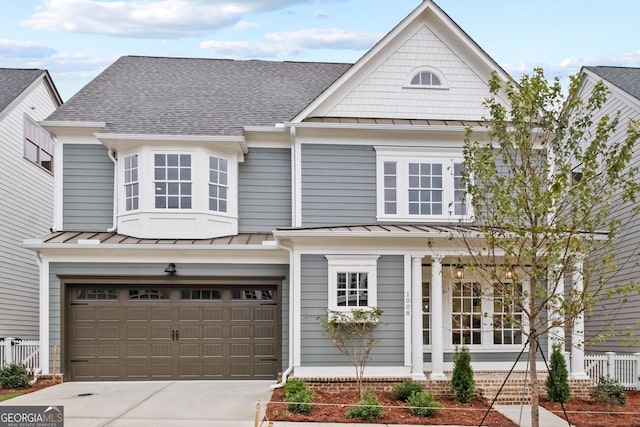 4002 Potter Way, Woodstock, GA 30188 - view of front of house featuring a standing seam roof, roof with shingles, an attached garage, and driveway