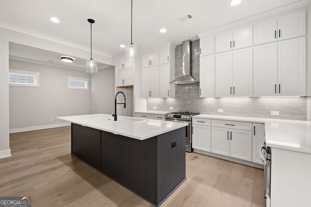 4002 Potter Way, Woodstock, GA 30188 - kitchen featuring wall chimney range hood, gas stove, a sink, tasteful backsplash, and light wood-style floors
