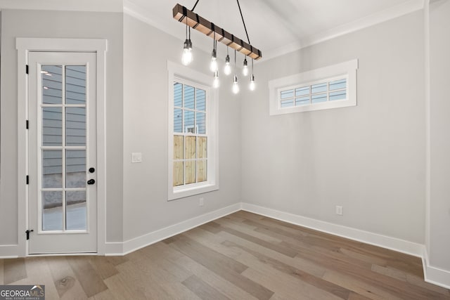 4002 Potter Way, Woodstock, GA 30188 - unfurnished dining area with wood finished floors, crown molding, and baseboards