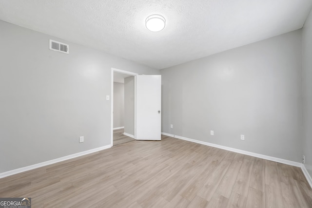 113 Tuxworth Cir, Decatur, GA 30033 - empty room with light wood-style floors, baseboards, and a textured ceiling