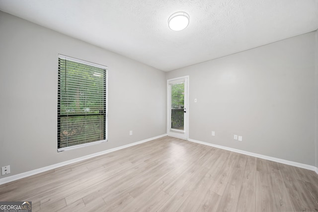 113 Tuxworth Cir, Decatur, GA 30033 - empty room featuring light wood-style floors, baseboards, and a textured ceiling