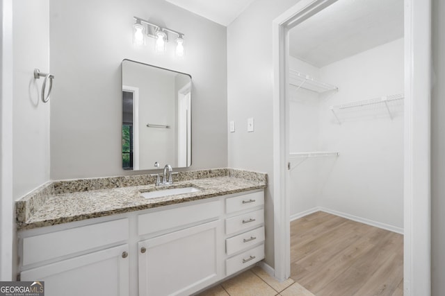 113 Tuxworth Cir, Decatur, GA 30033 - bathroom with vanity, wood finished floors, a walk in closet, and baseboards
