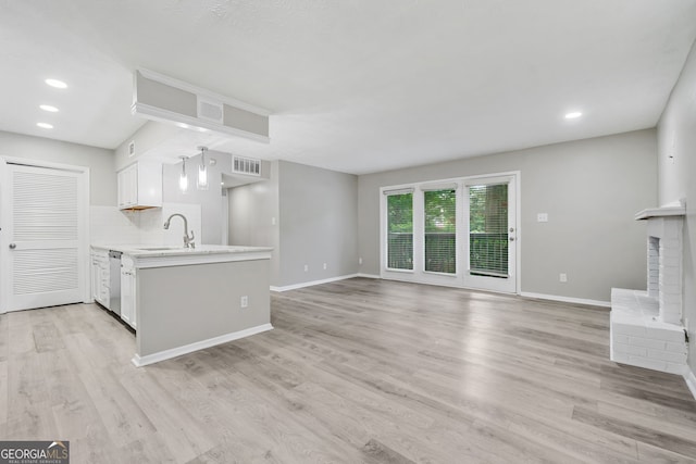 113 Tuxworth Cir, Decatur, GA 30033 - kitchen featuring stainless steel dishwasher, a sink, light countertops, baseboards, and a peninsula
