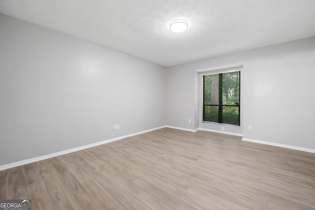 113 Tuxworth Cir, Decatur, GA 30033 - empty room featuring light wood-style floors, baseboards, and a textured ceiling
