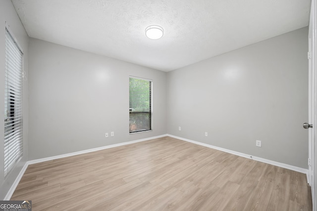113 Tuxworth Cir, Decatur, GA 30033 - unfurnished bedroom with light wood-type flooring, baseboards, and a textured ceiling