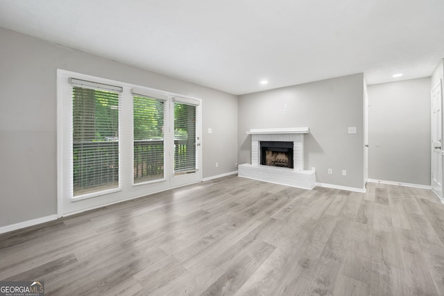113 Tuxworth Cir, Decatur, GA 30033 - unfurnished living room featuring light wood-style flooring, a brick fireplace, recessed lighting, and baseboards
