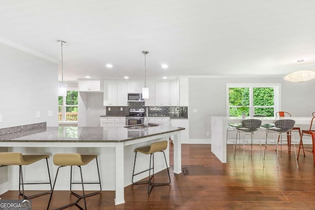 347 Chip Rd, Stone Mountain, GA 30087 - kitchen featuring stainless steel electric stove, crown molding, white cabinets, dark stone counters, and dark wood-type flooring