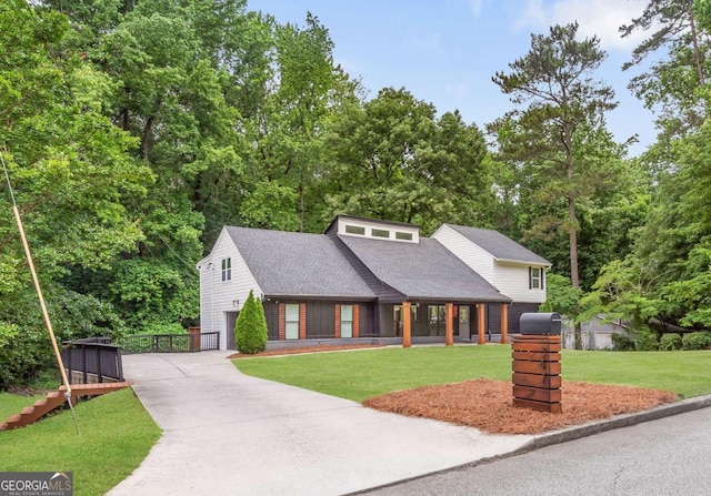 347 Chip Rd, Stone Mountain, GA 30087 - view of front facade featuring driveway, roof with shingles, a front yard, and a garage