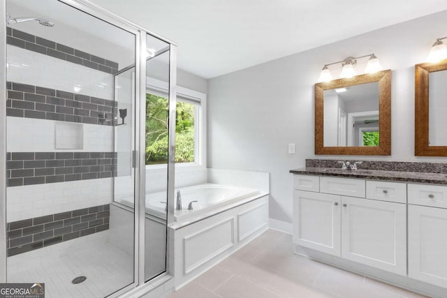 347 Chip Rd, Stone Mountain, GA 30087 - bathroom with a shower stall, vanity, a garden tub, tile patterned flooring, and baseboards