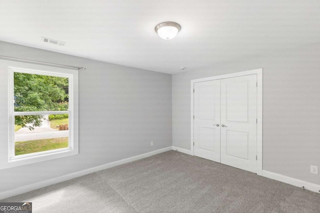 347 Chip Rd, Stone Mountain, GA 30087 - unfurnished bedroom with baseboards, carpet, and a closet