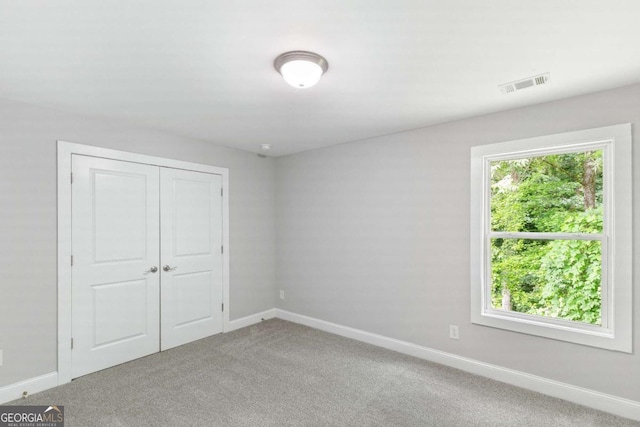 347 Chip Rd, Stone Mountain, GA 30087 - unfurnished bedroom featuring baseboards, carpet, and a closet
