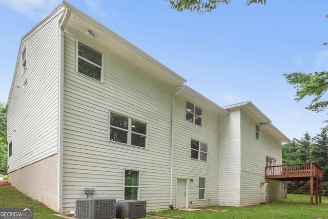347 Chip Rd, Stone Mountain, GA 30087 - rear view of property featuring a wooden deck, central AC unit, and a lawn