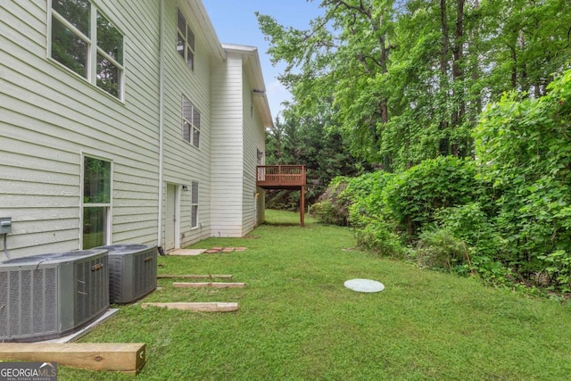 347 Chip Rd, Stone Mountain, GA 30087 - view of green lawn with central AC unit and a deck
