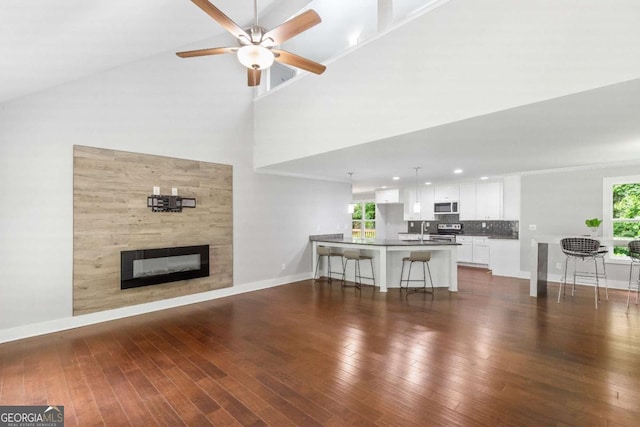 347 Chip Rd, Stone Mountain, GA 30087 - living room featuring baseboards, dark wood-style flooring, and a high ceiling