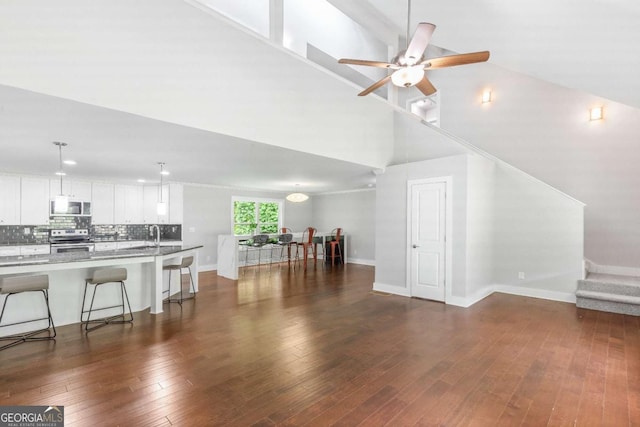 347 Chip Rd, Stone Mountain, GA 30087 - living room with high vaulted ceiling, dark wood-style floors, baseboards, and ceiling fan