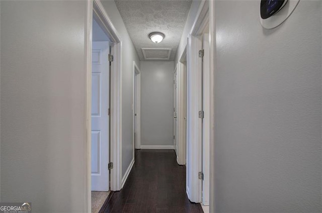 123 Mill Ln, Dallas, GA 30157 - corridor featuring a textured ceiling, wood finished floors, attic access, and baseboards