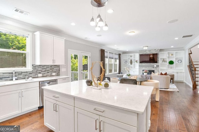 667 Creswell Park, Smyrna, GA 30082 - kitchen with dishwasher, a sink, backsplash, white cabinets, and a kitchen island