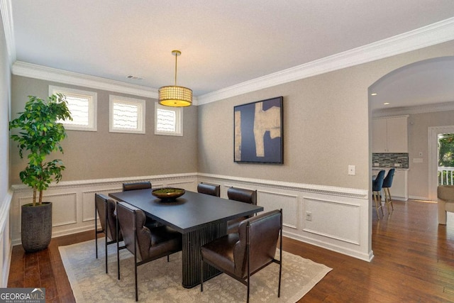 667 Creswell Park, Smyrna, GA 30082 - dining room with arched walkways, dark wood finished floors, crown molding, a decorative wall, and wainscoting