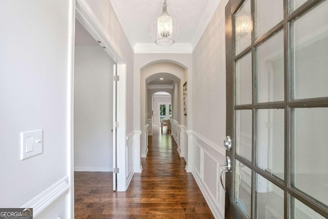 667 Creswell Park, Smyrna, GA 30082 - hallway featuring arched walkways, a chandelier, crown molding, dark wood-type flooring, and a decorative wall