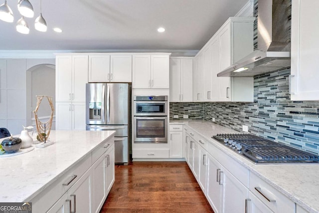 667 Creswell Park, Smyrna, GA 30082 - kitchen with stainless steel appliances, wall chimney exhaust hood, arched walkways, white cabinetry, and recessed lighting
