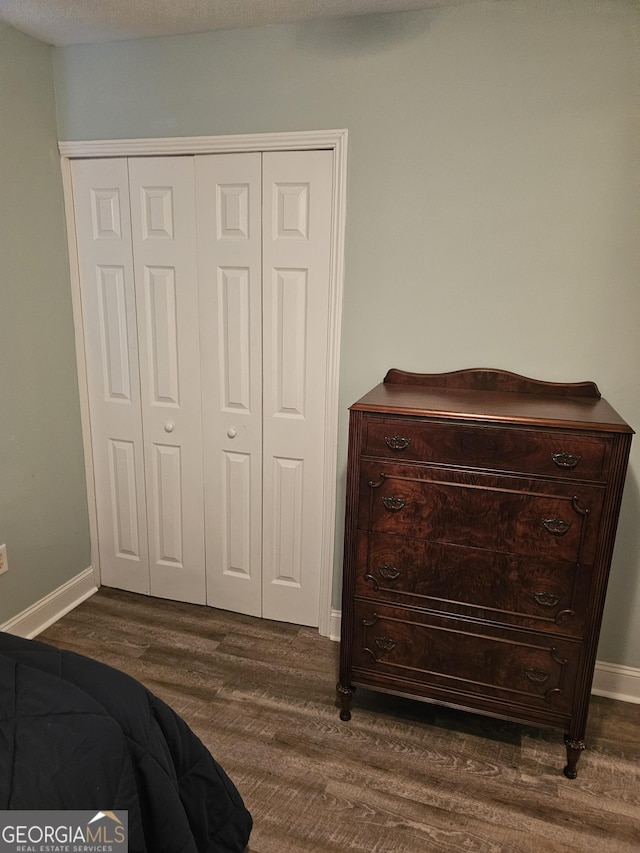 127 Azalea Rd Apt A103, Midway, GA 31320 - bedroom with dark wood finished floors, a closet, and baseboards
