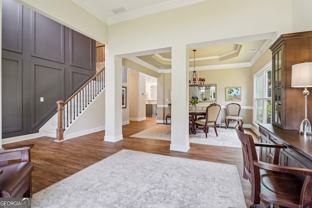 12645 Morningpark Cir, Alpharetta, GA 30004 - living area with dark wood-style floors, ornamental molding, stairs, baseboards, and a chandelier