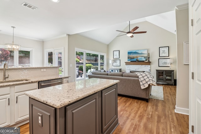 12645 Morningpark Cir, Alpharetta, GA 30004 - kitchen featuring a sink, stainless steel dishwasher, a ceiling fan, healthy amount of natural light, and lofted ceiling