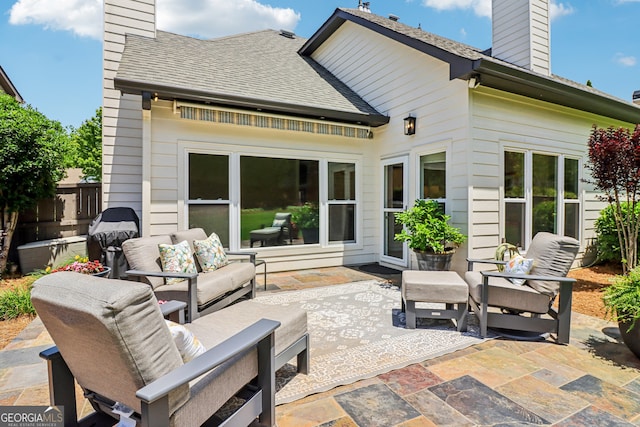 12645 Morningpark Cir, Alpharetta, GA 30004 - back of house with a chimney, a patio area, outdoor lounge area, and roof with shingles