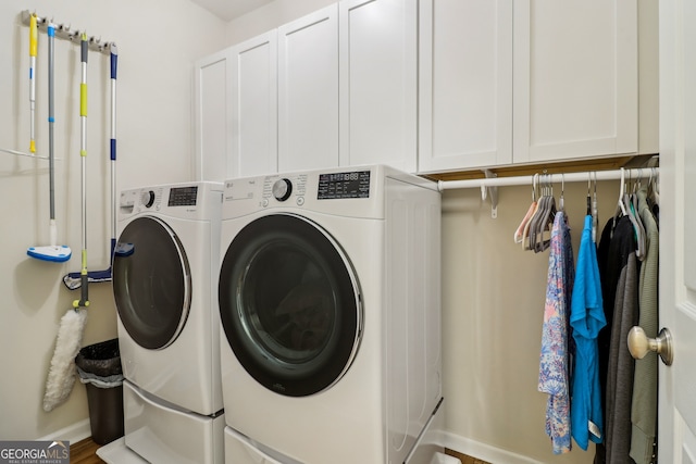 12645 Morningpark Cir, Alpharetta, GA 30004 - washroom with washing machine and clothes dryer, cabinet space, and baseboards