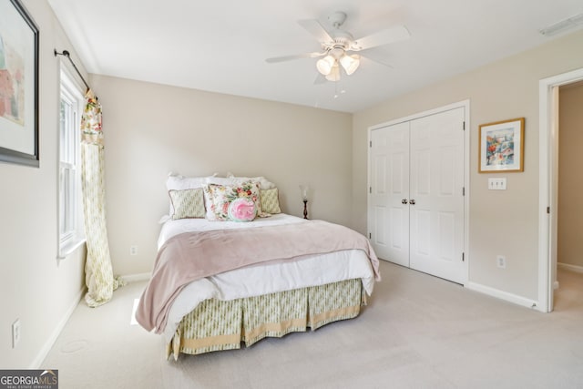 12645 Morningpark Cir, Alpharetta, GA 30004 - bedroom with carpet flooring, baseboards, a closet, and a ceiling fan