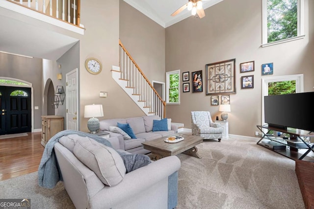 206 Kingsley Way, Woodstock, GA 30188 - living room featuring arched walkways, a high ceiling, healthy amount of natural light, and a ceiling fan
