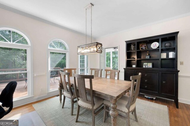 206 Kingsley Way, Woodstock, GA 30188 - dining room with plenty of natural light, ornamental molding, wood finished floors, a chandelier, and baseboards