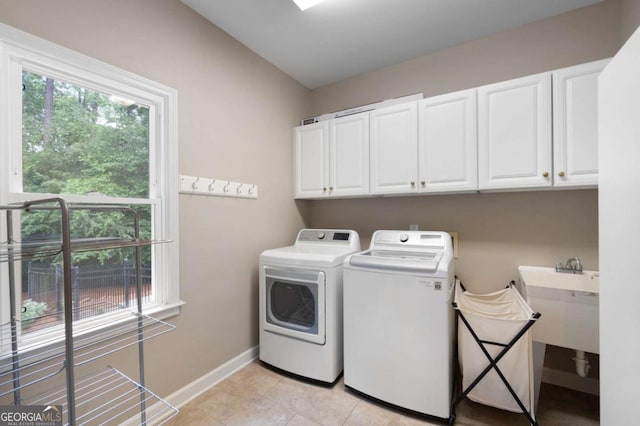 206 Kingsley Way, Woodstock, GA 30188 - laundry room with cabinet space, washing machine and clothes dryer, plenty of natural light, and baseboards