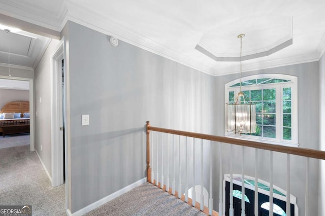 206 Kingsley Way, Woodstock, GA 30188 - hallway with attic access, carpet, ornamental molding, a raised ceiling, and baseboards