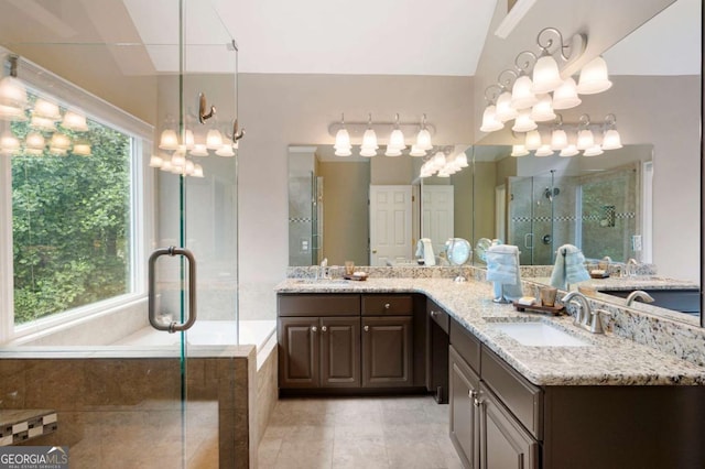 206 Kingsley Way, Woodstock, GA 30188 - full bath featuring a stall shower, double vanity, plenty of natural light, and vaulted ceiling