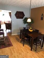 5658 Wind Gate Ln, Lithonia, GA 30058 - dining space with light wood-type flooring and baseboards