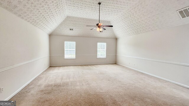 4676 Shaded Oak Ln, Forest Park, GA 30297 - spare room with vaulted ceiling, a ceiling fan, carpet flooring, and baseboards
