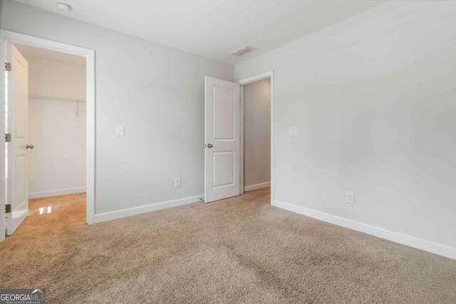 1227 Herty Dr, Marietta, GA 30062 - unfurnished bedroom with a spacious closet, baseboards, carpet flooring, and a closet