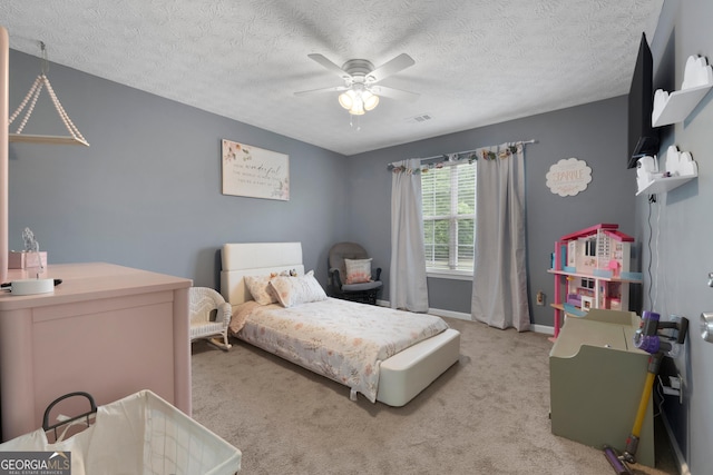 1195 New Hope Rd, Locust Grove, GA 30248 - bedroom with light colored carpet, a textured ceiling, baseboards, and a ceiling fan
