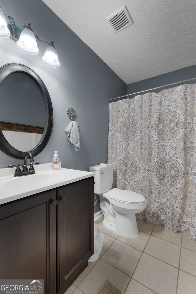 1195 New Hope Rd, Locust Grove, GA 30248 - bathroom with toilet, vanity, tile patterned floors, and a textured ceiling