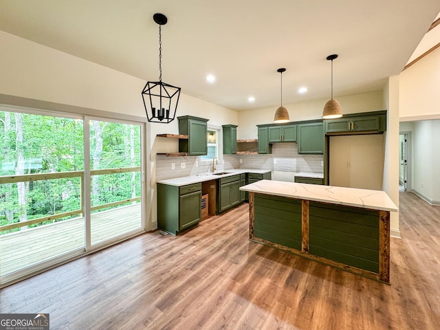 169 View St, Clarkesville, GA 30523 - kitchen with green cabinets, backsplash, light wood-type flooring, hanging light fixtures, and recessed lighting