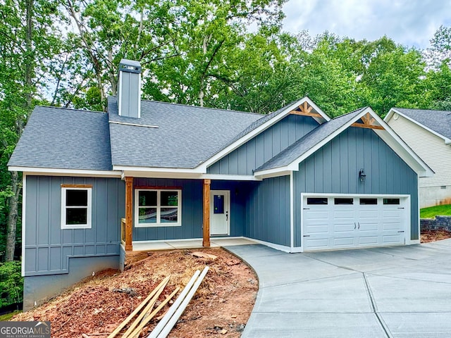 169 View St, Clarkesville, GA 30523 - view of front facade featuring roof with shingles, a garage, a porch, concrete driveway, and board and batten siding