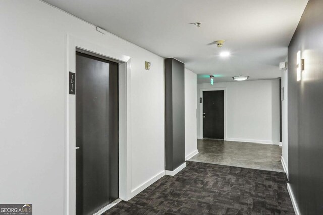 800 Peachtree St NE Unit 1014, Atlanta, GA 30308 - hall featuring baseboards and dark carpet