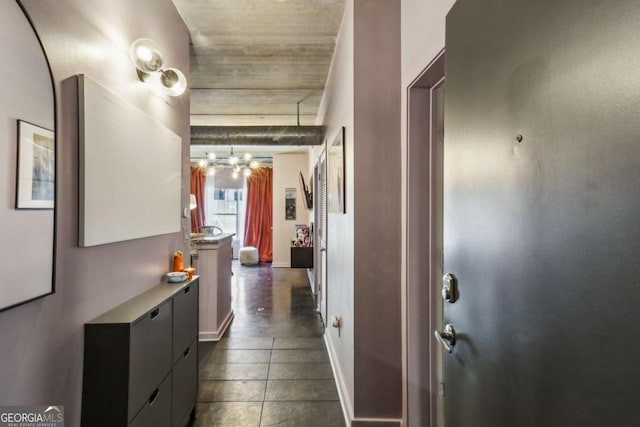 800 Peachtree St NE Unit 1014, Atlanta, GA 30308 - hall with a chandelier and dark tile patterned floors