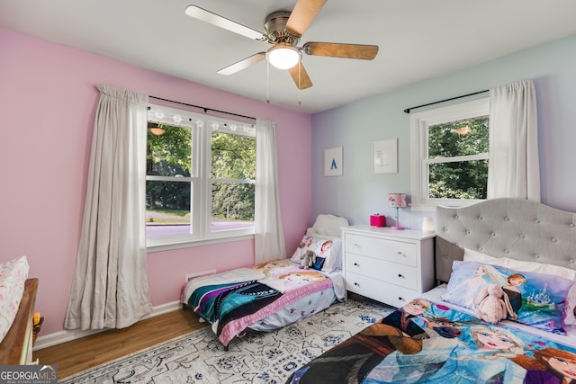 2575 Dobbs Dr NW, Kennesaw, GA 30152 - bedroom featuring wood finished floors, multiple windows, a ceiling fan, and baseboards