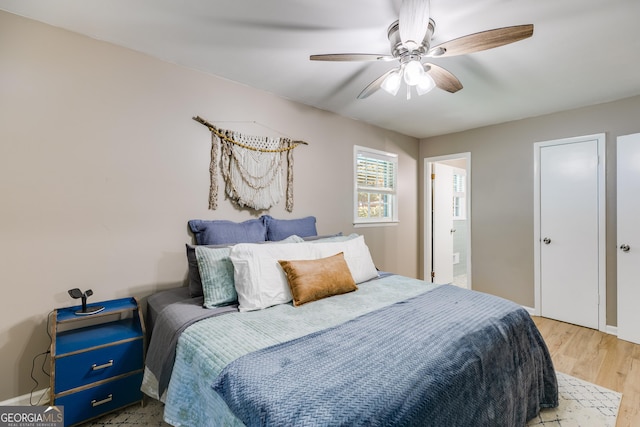 2575 Dobbs Dr NW, Kennesaw, GA 30152 - bedroom with wood finished floors, ceiling fan, and ensuite bath
