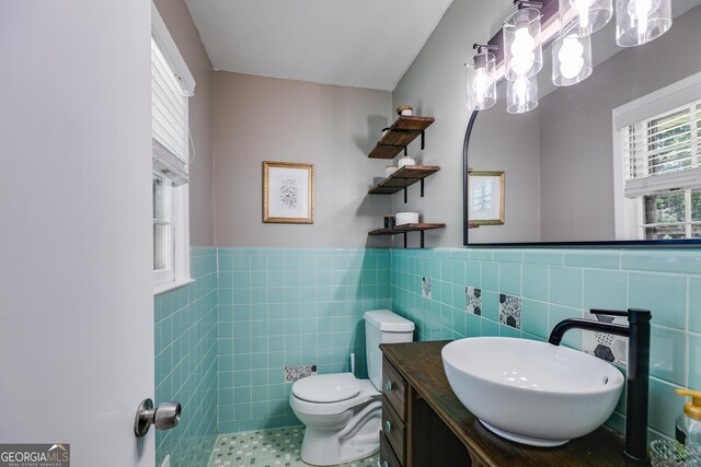 2575 Dobbs Dr NW, Kennesaw, GA 30152 - half bathroom featuring toilet, vanity, tile walls, wainscoting, and a chandelier