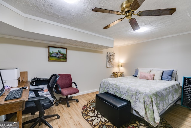 2575 Dobbs Dr NW, Kennesaw, GA 30152 - bedroom with a textured ceiling, an office area, ornamental molding, light wood-style floors, and baseboards