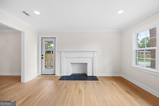 1905 Azalea, Valdosta, GA 31602 - unfurnished living room with plenty of natural light, baseboards, light wood-type flooring, a brick fireplace, and crown molding
